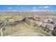 Scenic aerial view of a neighborhood with lush greenery and a backdrop of majestic mountains at 3266 Yale Dr, Broomfield, CO 80023