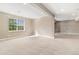 Bright basement featuring a large window and a large, open carpeted area at 3266 Yale Dr, Broomfield, CO 80023