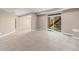 Spacious carpeted basement with sliding glass doors leading to an outdoor staircase at 3266 Yale Dr, Broomfield, CO 80023