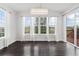 Bright dining room featuring hardwood floors, large windows, and a modern chandelier at 3266 Yale Dr, Broomfield, CO 80023