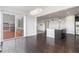 Open dining area with hardwood floors, access to the deck, and view of the kitchen island at 3266 Yale Dr, Broomfield, CO 80023