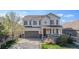 Charming two-story home with covered porch, gray siding, and a meticulously maintained front yard at 3266 Yale Dr, Broomfield, CO 80023