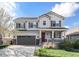 Charming two-story home with covered porch, gray siding, and a meticulously maintained front yard at 3266 Yale Dr, Broomfield, CO 80023