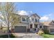 Charming two-story home with covered porch, gray siding, and a meticulously maintained front yard at 3266 Yale Dr, Broomfield, CO 80023