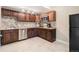 Cozy kitchen featuring wood cabinets, a stainless steel dishwasher, and granite countertops at 3266 Yale Dr, Broomfield, CO 80023