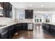 Beautiful kitchen with dark cabinets, modern backsplash, and stainless steel dishwasher at 3266 Yale Dr, Broomfield, CO 80023