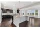 Modern kitchen features a large island, pendant lights, and dark cabinets at 3266 Yale Dr, Broomfield, CO 80023