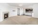 Open living room flows into a kitchen with dark wood floors and fireplace at 3266 Yale Dr, Broomfield, CO 80023