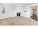 Spacious living room with fireplace, neutral carpet, and modern light fixture at 3266 Yale Dr, Broomfield, CO 80023