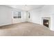 Bright living room with a fireplace, neutral carpet, and large windows for natural light at 3266 Yale Dr, Broomfield, CO 80023