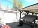 Backyard patio with dining, detached garage with roll-up door, and under-cover area for lounging at 4411 W Center Ave, Denver, CO 80219