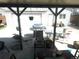Outdoor patio with grill and dining set, showcasing an detached garage with roll-up door at 4411 W Center Ave, Denver, CO 80219