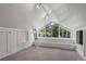 Spacious attic room featuring bright, natural light and a large window overlooking greenery at 1010 Euclid Ave, Boulder, CO 80302