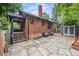 Charming brick home featuring a stone patio, covered porch and well maintained landscaped backyard at 1010 Euclid Ave, Boulder, CO 80302