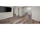 Open basement layout featuring wood-look floors, a shelving unit and access to the laundry room at 1010 Euclid Ave, Boulder, CO 80302