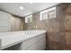 Bathroom vanity area with a quartz countertop, decorative tile wall and ample lighting at 1010 Euclid Ave, Boulder, CO 80302