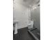 Modern bathroom featuring a glass-enclosed shower with gray tile and black honeycomb flooring at 1010 Euclid Ave, Boulder, CO 80302