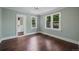 Bedroom has hardwood floors, two windows, light blue walls, and access to a spacious walk-in closet at 1010 Euclid Ave, Boulder, CO 80302