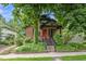 Charming brick home with mature trees, inviting porch, and landscaped front yard offers curb appeal at 1010 Euclid Ave, Boulder, CO 80302