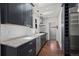 Galley kitchen with shaker cabinets, marble countertops, stainless steel appliances, and tiled backsplash at 1010 Euclid Ave, Boulder, CO 80302