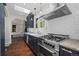 Kitchen features shaker cabinets, marble countertops, stainless steel appliances, tile backsplash and hardwood flooring at 1010 Euclid Ave, Boulder, CO 80302
