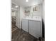 Bright laundry room with white appliances and dark floors located in a finished basement at 1010 Euclid Ave, Boulder, CO 80302