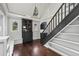 Light-filled living room featuring hardwood floors, a staircase, and a modern cabinet at 1010 Euclid Ave, Boulder, CO 80302
