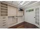 Walk-in closet with custom shelving, drawers, a skylight, and hardwood flooring at 1010 Euclid Ave, Boulder, CO 80302