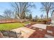 Expansive backyard with a well-maintained lawn and mature trees, perfect for outdoor activities at 3067 Robin Way, Denver, CO 80222