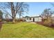 Lush backyard features a green lawn, trees, fresh mulch, and a patio at 3067 Robin Way, Denver, CO 80222