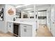 Stylish bar area with a wine refrigerator and modern cabinetry, great for entertaining at 3067 Robin Way, Denver, CO 80222