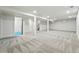 Large basement featuring neutral carpet, a pillar, and bright lighting, offers flexible space at 3067 Robin Way, Denver, CO 80222