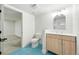 Modern bathroom features blue tiled floors, light-wood vanity and updated fixtures at 3067 Robin Way, Denver, CO 80222