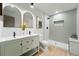 Modern bathroom features a double vanity, large mirrors, and a tiled walk-in shower at 3067 Robin Way, Denver, CO 80222