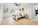 Bright bedroom features a ceiling fan, wood floors, a window and a minimalistic design at 3067 Robin Way, Denver, CO 80222