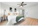 Bright bedroom features a ceiling fan, wood floors, a window and artwork at 3067 Robin Way, Denver, CO 80222