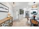 Inviting entryway leading to a modern kitchen and dining area with stylish lighting at 3067 Robin Way, Denver, CO 80222