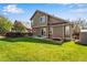 Landscaped backyard featuring a well-maintained lawn and fenced perimeter at 12535 Forest View St, Broomfield, CO 80020