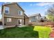 View of the backyard featuring a green lawn, concrete patio, and privacy fence at 12535 Forest View St, Broomfield, CO 80020