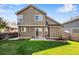 Spacious backyard with lush green lawn, patio area, and a wooden garden box at 12535 Forest View St, Broomfield, CO 80020