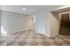 Finished basement with checkerboard carpet, closet, and stairs leading to upper floor at 12535 Forest View St, Broomfield, CO 80020