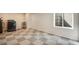 Finished basement area with checkerboard carpet and natural light from a window well at 12535 Forest View St, Broomfield, CO 80020