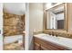 Beautiful bathroom featuring tile floors, tiled shower, and lovely vanity with countertop sink at 12535 Forest View St, Broomfield, CO 80020