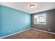 Inviting bedroom has a blue accent wall and grey walls at 12535 Forest View St, Broomfield, CO 80020