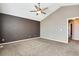 This bedroom includes neutral walls, carpeting, a ceiling fan, and natural light at 12535 Forest View St, Broomfield, CO 80020