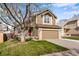 Charming two-story home with a well-manicured lawn, mature trees, and a two car garage at 12535 Forest View St, Broomfield, CO 80020