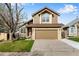 Charming two-story house featuring a spacious driveway and attached garage, surrounded by a lush green lawn at 12535 Forest View St, Broomfield, CO 80020