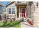Inviting front entrance with a red door, set amidst a well-maintained lawn and tidy landscaping at 12535 Forest View St, Broomfield, CO 80020