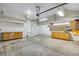 Spacious garage with storage cabinets and overhead lighting at 12535 Forest View St, Broomfield, CO 80020