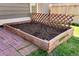 Close up of a wooden garden box with brick trim and a lattice at 12535 Forest View St, Broomfield, CO 80020